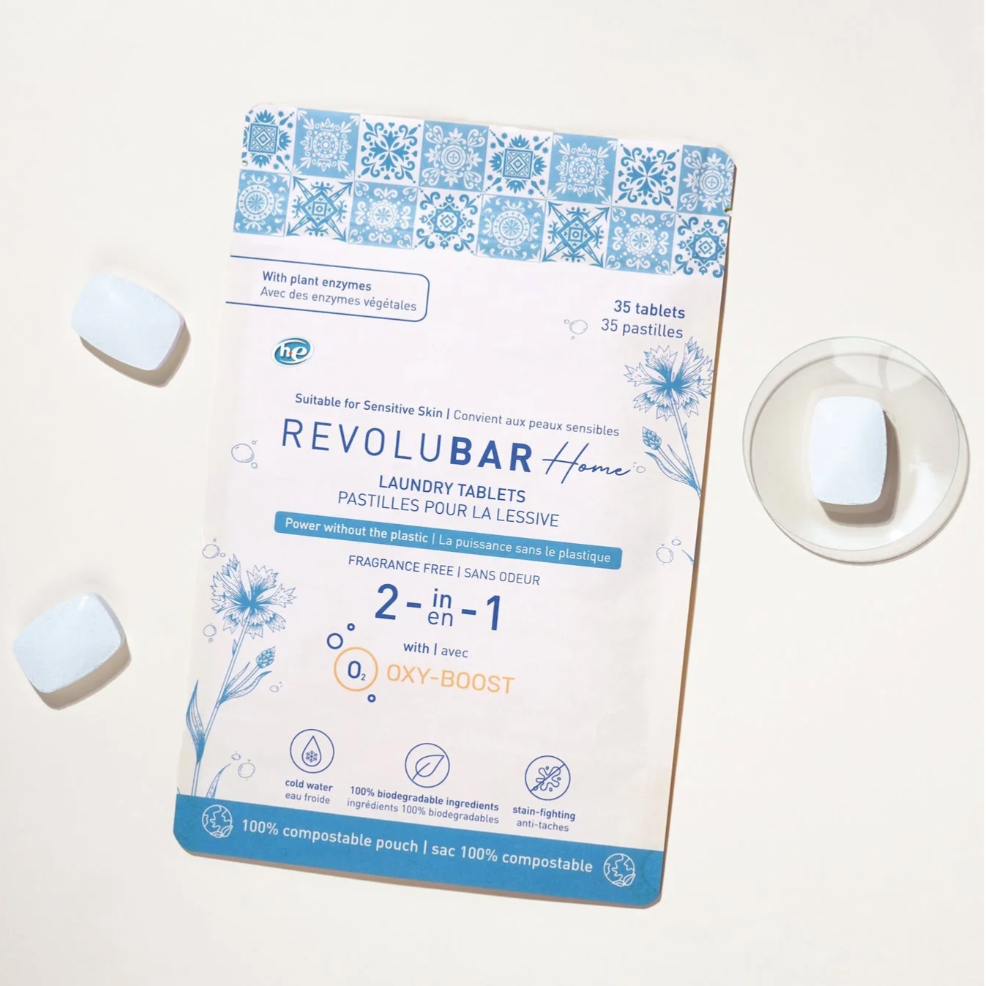 A box of TANIT laundry detergent tablets with three tablets displayed in front, the box has text and branding.