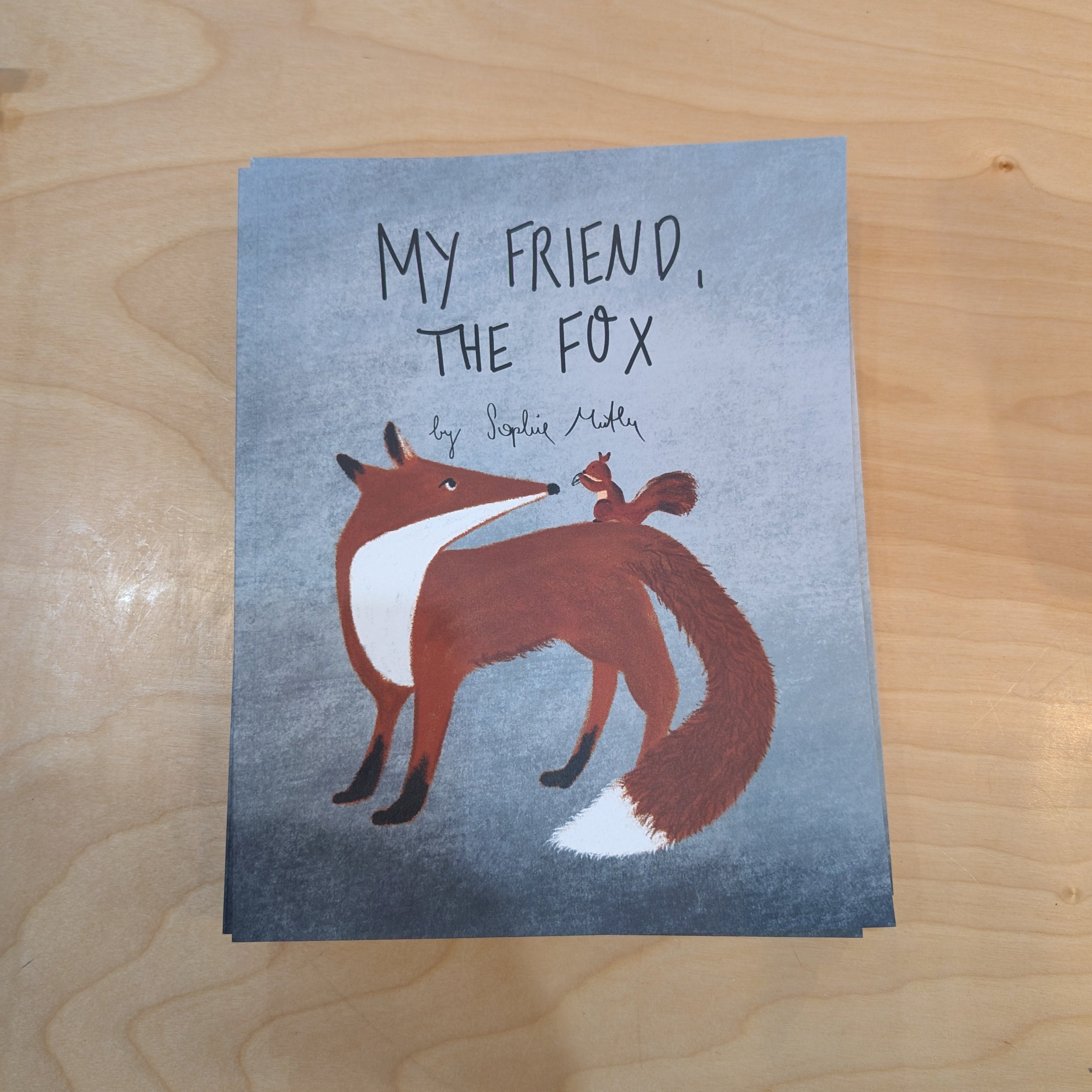 Book titled 'My Friend, The Fox' on a wooden surface