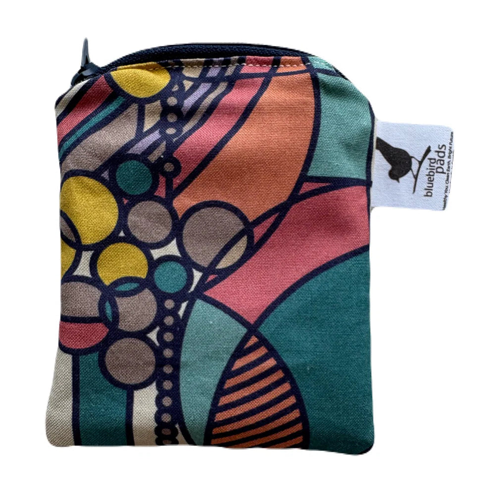 Colorful fabric pouch with abstract design on a white background
